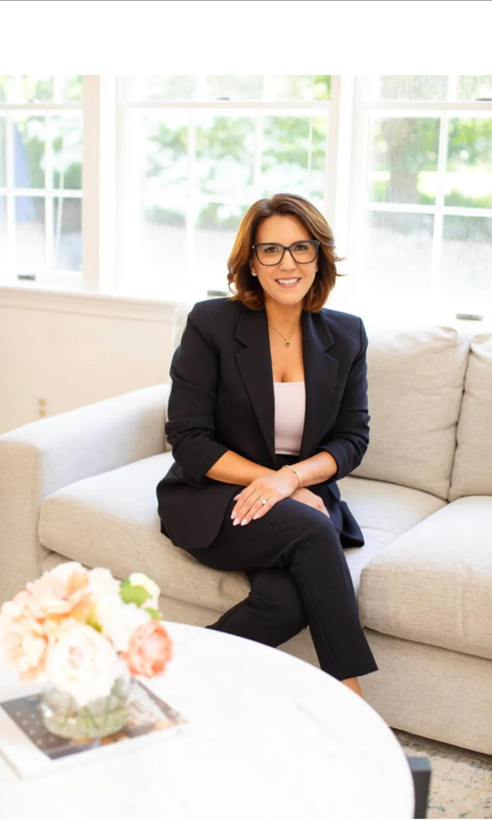 Mai Ly Musto seated in a bright living room